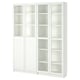 A BILLY bookcase, white, with glass doors and adjustable shelves. Its a tall, rectangular storage unit with multiple compartments.
