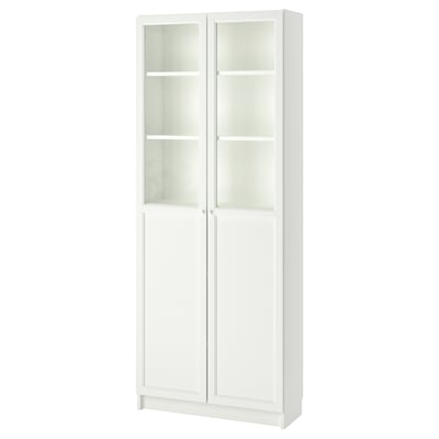 A white BILLY bookcase with glass doors. It a simple design with four adjustable shelves, suitable for versatile storage and display.
