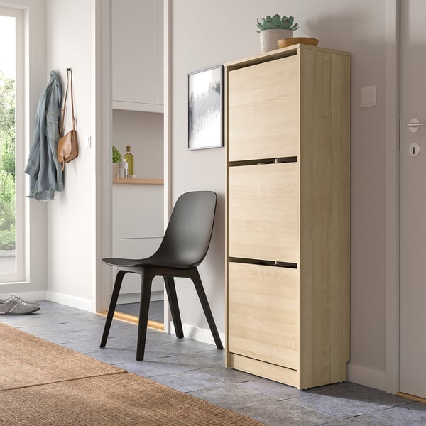 Light oak shoe cabinet with 3 compartments, fits corner, adjustable storage.