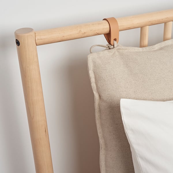 Wooden bed frame with beige fabric storage bag, quality craftsman design.