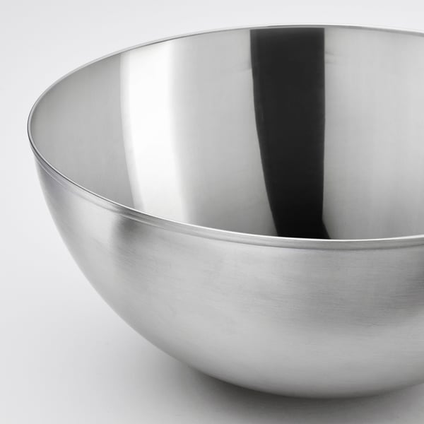 Stainless steel bowl, sleek and polished, shown in close-up highlighting its smooth, reflective surface.