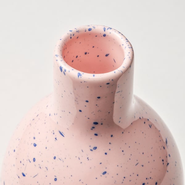 Vase with smoothly curved body, narrow neck, and hand-splashed blue dots, showcasing high-quality craftsmanship and a unique design.