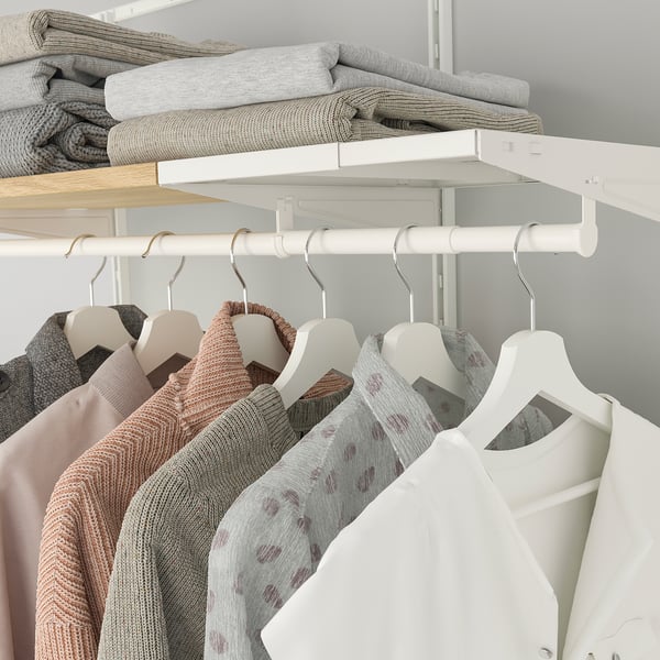 BOAXEL shelf & rail system with clothes and blankets.