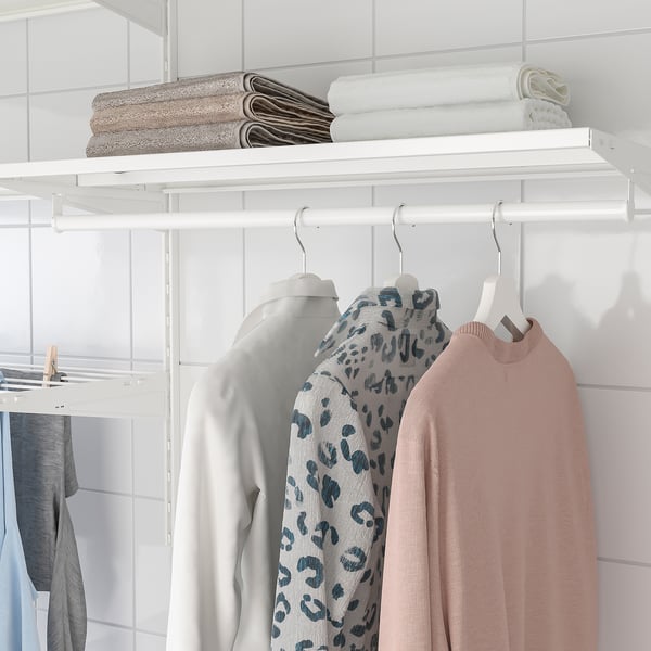 White closet with BOAXEL system: hanging clothes and folded towels on shelves.