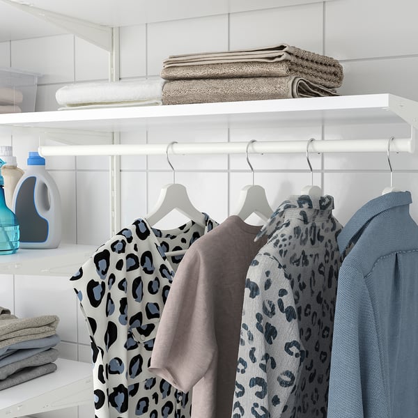 Neat closet with clothes, towels, and detergent.