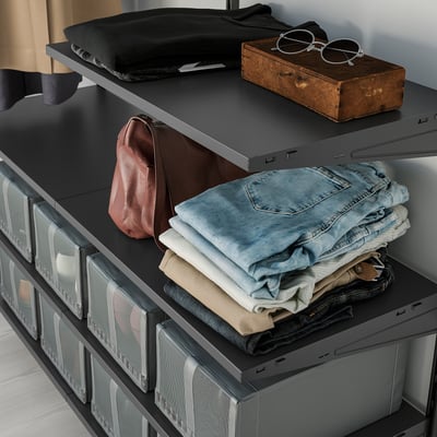 Black BOAXEL storage shelf with foldable jeans, red bag, wooden box, and black sweater on top.