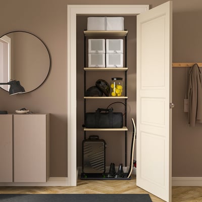BOAXEL storage with sports gear, luggage, and coat hanger beside door.
