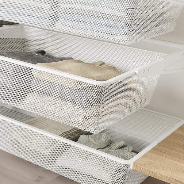 White wire mesh drawer units mounted on a wooden shelf, filled with neatly folded clothes.