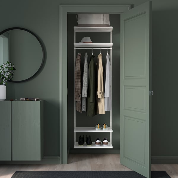 A green BOAXEL wall storage with hooks, shelves, minimalist design for organising outdoor clothing.