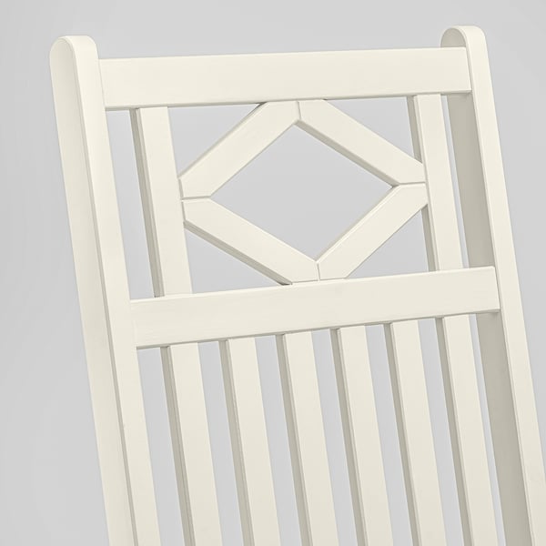White wooden chair back with geometric design and vertical slats, sturdy and stylish.
