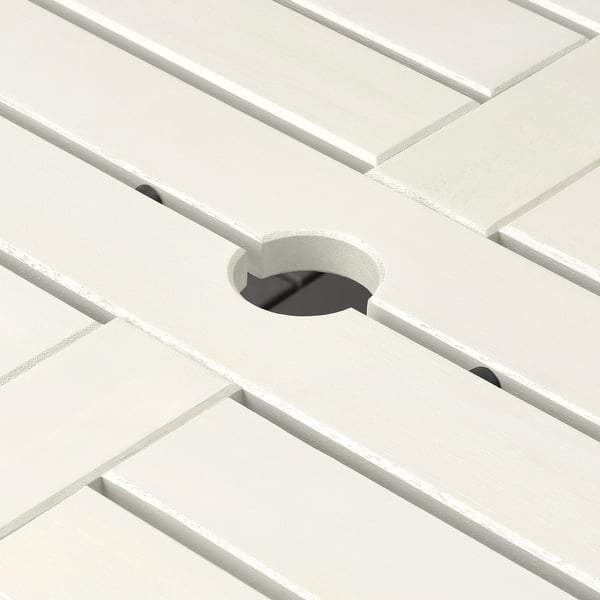 White acacia table with parasol hole, sleek design, robust construction for outdoor use.