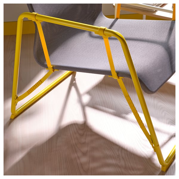Bright yellow metal-framed mesh chair with angled legs, designed for comfort and durability.