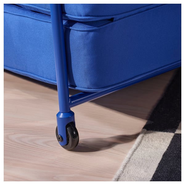 Close-up of a blue fabric chairs wheel, showcasing its sturdy metal frame and smooth caster, highlighting durability and mobility.