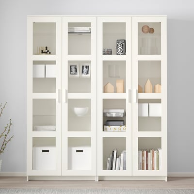White BRIMNES glass-door display cabinet with adjustable shelves for books and decor.