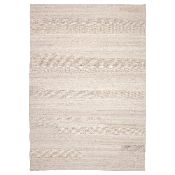 BRÖNDEN beige wool rug - handwoven, neutral, rectangular, textured pattern.
