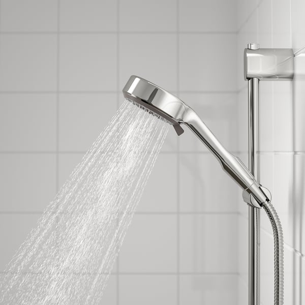 Modern chrome shower head with full spray pattern.