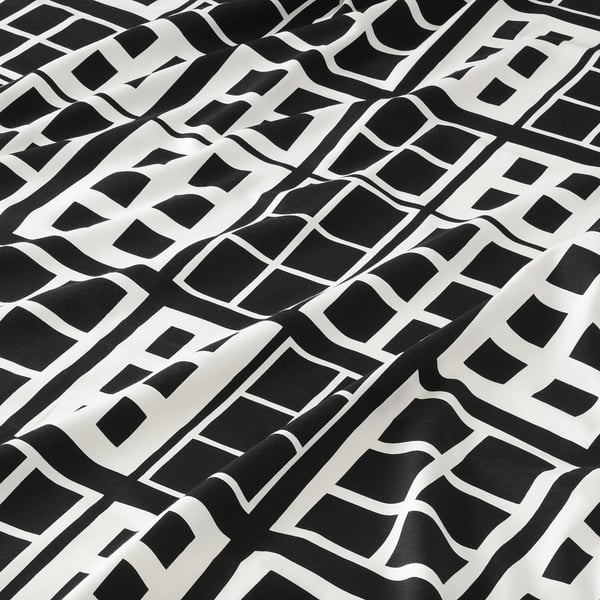 Black and white patterned fabric, intricate geometric design, high-quality cotton texture.
