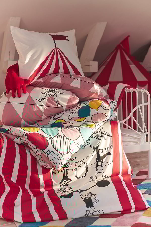 Playful circus-themed kids bedding with red, white, bright colours, stripes, and whimsical designs.
