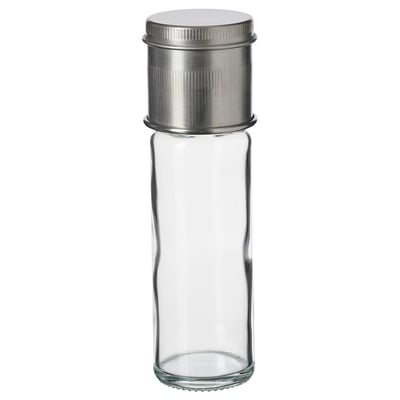 A CITRONHAJ spice jar with a clear glass body, silver metal lid, and ceramic grinder top. Its cylindrical and simple in design.