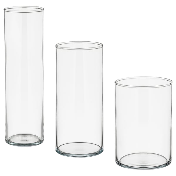 Three clear glass CYLINDERs in varying sizes, ideal for decoration and storage. Theyre simple, sleek, and can be stacked together.
