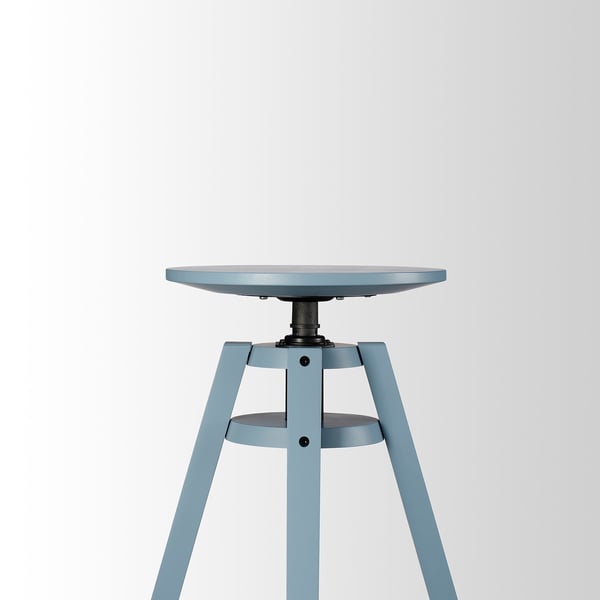 Blue adjustable height round stool with metal legs and footrest.