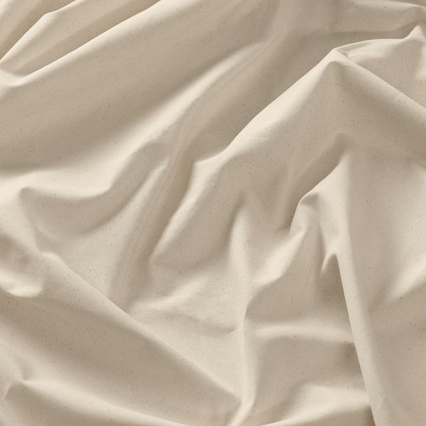 Soft, cream-colored cotton fabric with subtle texture, gently draped, showcasing natural weave and quality.