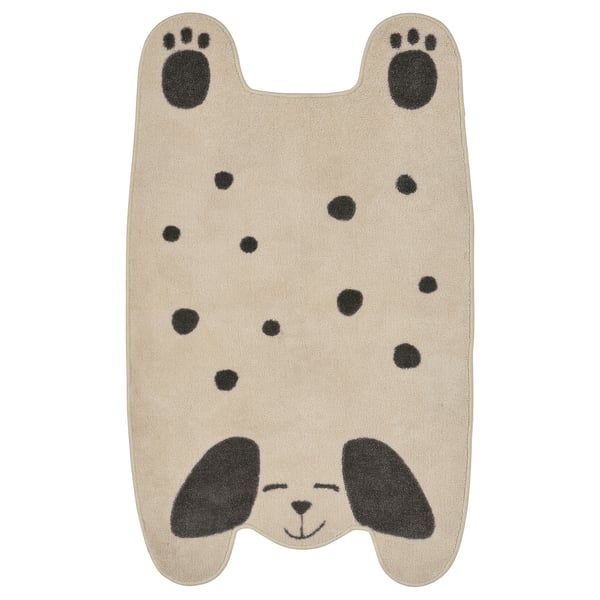 Cute tan puppy-shaped rug with black spots, paws, and eyes; soft, recycled polyester.