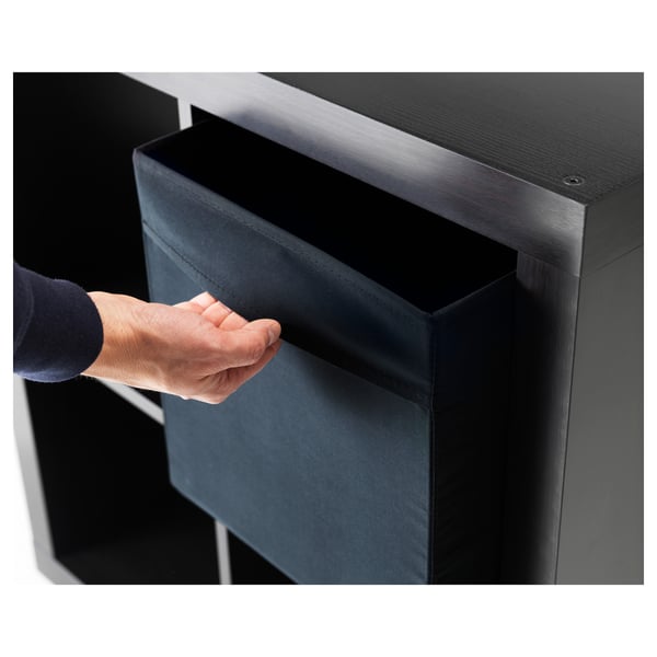 Hand pulling out DRÖNA fabric storage box from shelf.