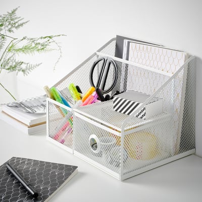 White DRÖNJÖNS desk organizer with pens, scissors, and notebooks; fits well on desk with other supplies.