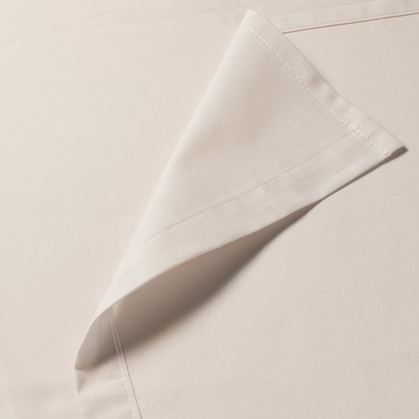 Close-up of soft, white cotton fabric showcasing stitched seam and smooth texture, highlighting quality and comfort.