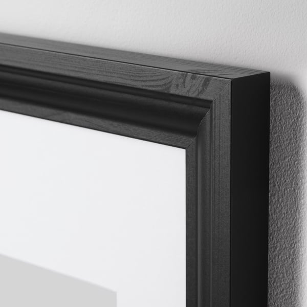 Black picture frame with smooth edges and plastic front protection. Shows robust design, perfect for home decor.