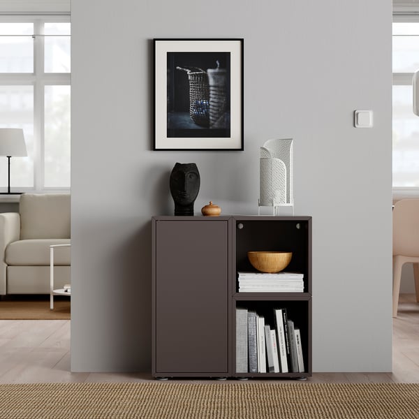 Modern living room with grey EKET storage, books, and abstract art.
