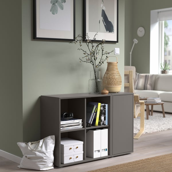 Grey EKET storage in living room with books and decor. Compact & sleek.