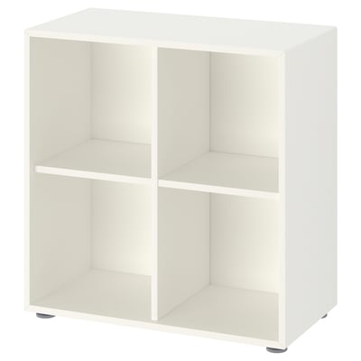 A white EKET storage unit with four open compartments, made of particleboard and fiberboard, standing on adjustable feet.