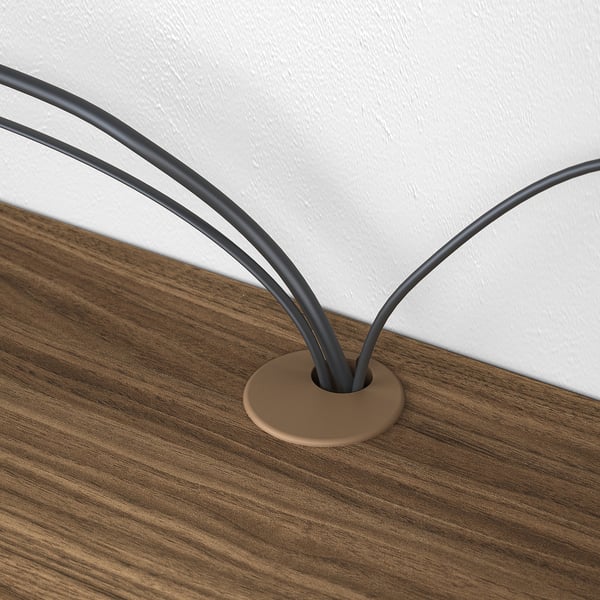 Close-up of EKET cable management: cords neatly fed through top of wooden media shelf.