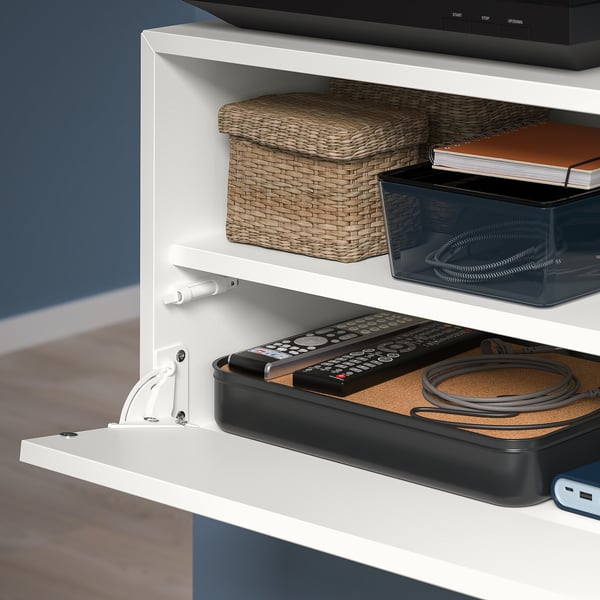 Wall-mounted shelves with open compartments. Top holds tissues and papers, bottom stores remotes, cables, and usb hub on cork.