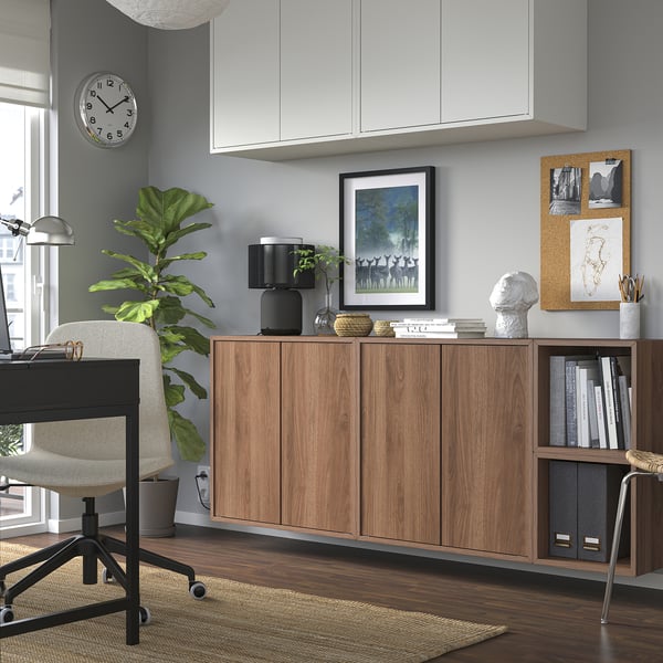 Modern home office with EKET storage, plant, desk, and wall decor.
