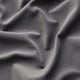 Close-up of soft, textured grey fabric, likely a sofa cover, with visible weave patterns and gentle folds, emphasising its smooth and inviting feel.