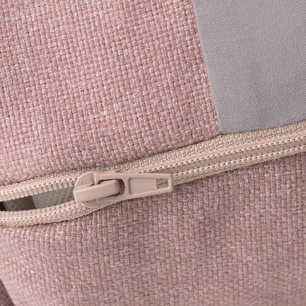 Closeup of pink recliners zip; shows sturdy material and clean finish.