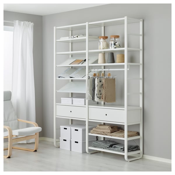 White ELVARLI storage system with shelves, jars, boxes, and folded clothes. Integrated drawer closes softly.