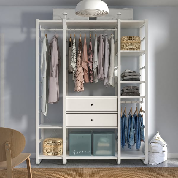 White ELVARLI wardrobe clothes, shelves with woven baskets, drawers, and a hanging chair bag. It attaches to the wall.