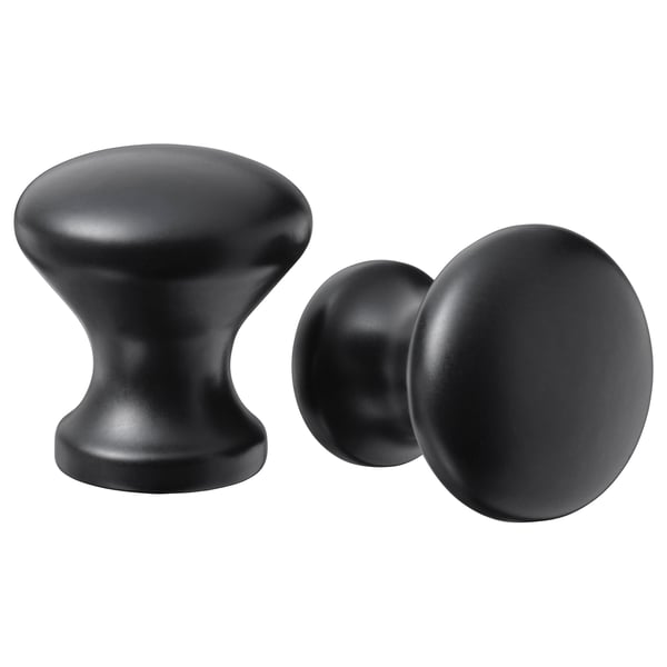 Two black cabinet knobs; one rounded, one cylindrical, both stylish and modern.