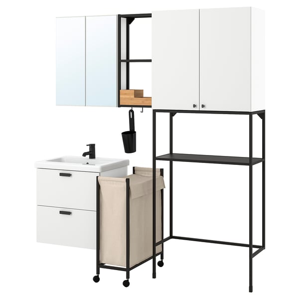 Modern white bathroom setup: cabinet, sink, mirror, shelves, laundry bag & hooks in black & wood.