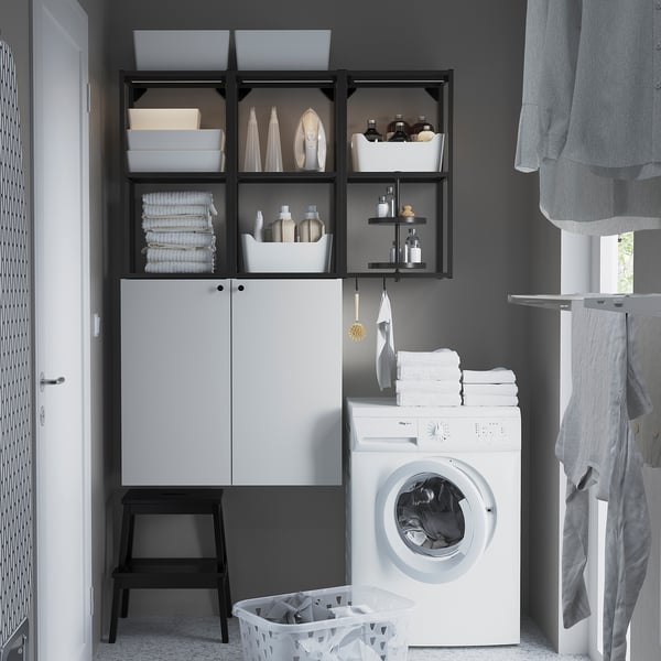 White ENHET storage combo above washer for laundry items. Sleek, modern design with open and closed storage.