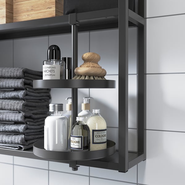 Black swivel shelf in bathroom holding bottles, brushes, and towels. Ehnet series compatible.
