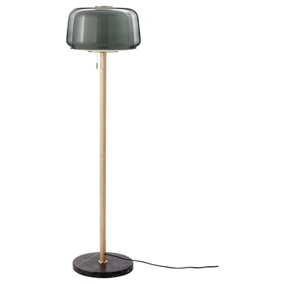 Minimalist floor lamp with smoked glass shade and wooden stem; sleek and modern design.