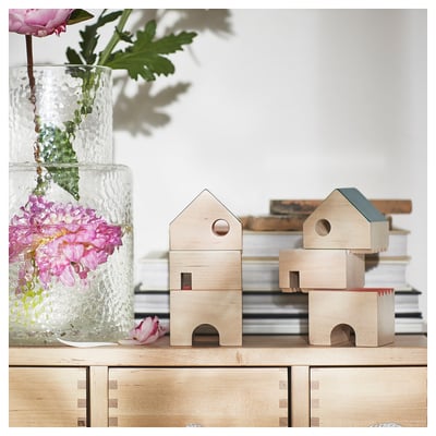 Wooden house decor, light natural wood, stackable blocks, flowers in vase.