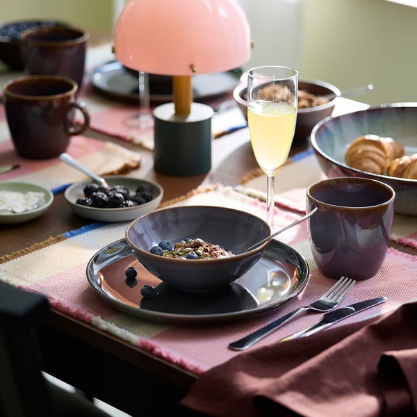 Breakfast table set with FÄRGKLAR purple bowls and mugs. Matte finish, simple design. Smaller than the lampshade.