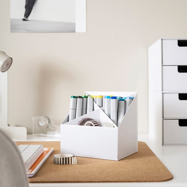 Desk organiser with four compartments, holding markers and tape, helping keep workspace neat.