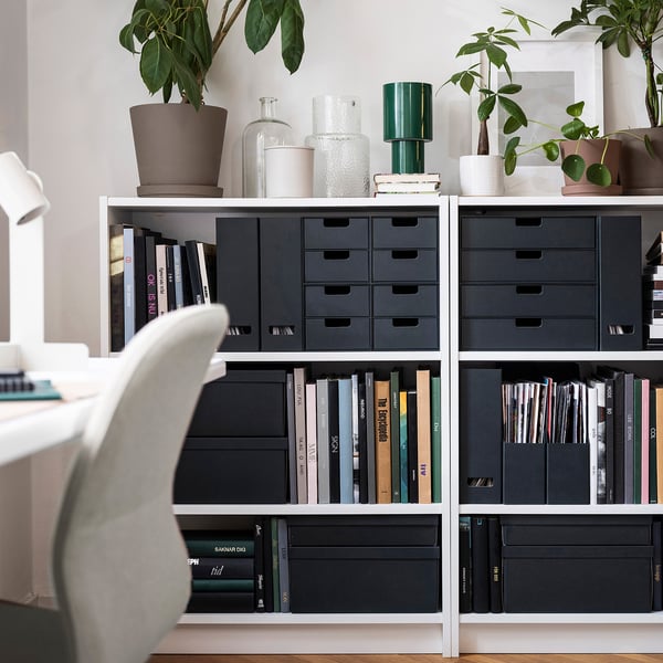 Modern office with bookshelf, FJÄDERHARV drawers, plants, chair.
